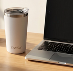 Tasse à café isolée OWAW Pause Blanc sur un bureau à côté d'un ordinateur portable